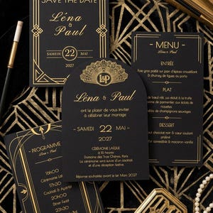May include: A set of black wedding stationery featuring gold geometric borders and text. The items include a Save the Date, a menu, and a program, all displaying the names Léna & Paul and the date May 22, 2027, with an arched invitation card.