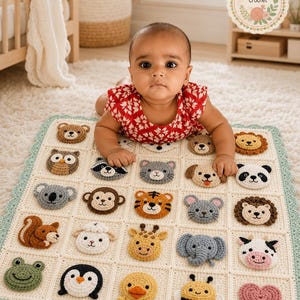 May include: A cream-colored crochet baby blanket featuring a grid of twenty-five square patches, each decorated with a unique, raised animal face or a heart. The blanket has a scalloped light green border and includes a Baby Bloom Crochet logo.