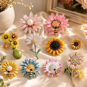 May include: A collection of ten floral-themed brooches featuring various designs including sunflowers, daisies, and bees. The pins are crafted with colorful enamel, sparkling rhinestones, and faux pearls, showcasing intricate petal and insect details.
