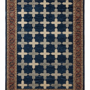 May include: A rectangular area rug featuring a deep blue field with a repeating pattern of light beige and grey cross shapes. The rug is framed by a wide, intricate border in shades of red, gold, and blue, finished with short beige fringe at both ends.