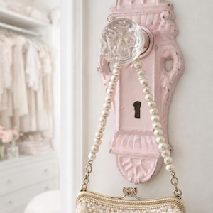 May include: A white ceramic mug with a black handle and the text "But First, Coffee" in a handwritten style. The mug is on a white surface. The mug is approximately 4 inches tall.