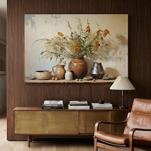 May include: A large rectangular wall art print featuring a still life composition of a ceramic bowl, a small pitcher, a speckled vase, a large round brown pot, and a dark metallic vase filled with dried orange flowers and tall grasses.