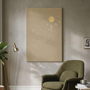 May include: A rectangular wall art print featuring a solid beige background with a pale yellow circular moon in the upper right quadrant and a scattered pattern of small white bird silhouettes flying in a diagonal formation across the canvas.