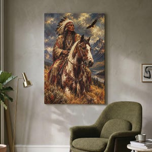 May include: A vertical wall art print depicting a person in traditional Native American regalia with a feathered headdress riding a brown and white horse. The scene features a mountainous landscape, golden grasses, and a flying eagle under a cloudy sky.