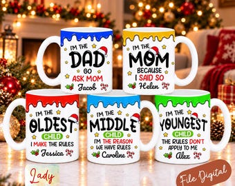 May include: Five white ceramic mugs with colourful drip designs at the top. Each mug features Christmas-themed text and graphics, including Santa hats and candy canes. The mugs are labelled for family members: Dad, Mom, Oldest, Middle, and Youngest child.