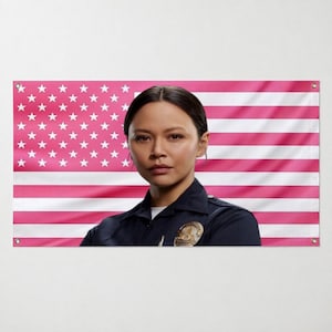May include: A person with dark hair wearing a dark blue collared uniform shirt with a gold-toned badge on the chest. The background is a horizontal banner featuring a pattern of white stars on a pink field and alternating pink and white stripes.
