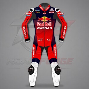 May include: A red, black, and white motorcycle racing suit featuring the Red Bull logo on the chest, GasGas branding on the arms and legs, and various sponsor logos including Motul, Michelin, and Akrapovic. The suit has white knee protectors.
