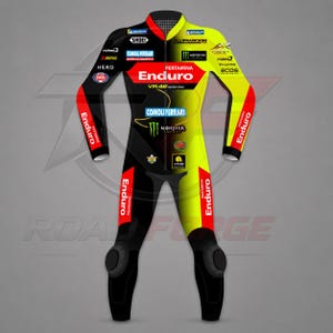 May include: A professional motorcycle racing suit featuring a black and neon yellow color scheme with red accents. The suit displays various sponsor logos including Pertamina Enduro, VR46 Racing Team, Monster Energy, Shoei, and Comoli Ferrari.