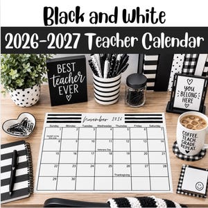 May include: A 2026-2027 teacher calendar featuring a black and white grid for November 2026. The desk setup includes a black sign reading Best Teacher Ever, a striped pen holder, a mug with text, a heart-shaped dish, and a spiral notebook.