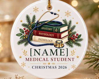May include: A round white ceramic ornament featuring a stack of three books labeled Anatomy, Physiology, and Pathology with a blue stethoscope draped over them. It includes pine branches, red berries, gold snowflakes, and the text [NAME] MEDICAL STUDENT CHRISTMAS 2026.