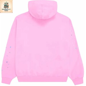 May include: A solid light pink hooded sweatshirt featuring long sleeves with small, scattered blue and white paint-like speckles on the outer arms. The garment has a standard hood, ribbed cuffs, and a ribbed hem, presented from a back view.