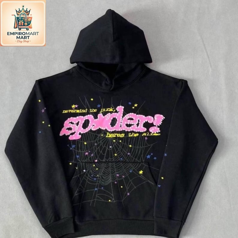 May include: A black hooded sweatshirt featuring a large pink graphic on the chest that reads "spider!" with the text "nevermind the punk, heres the slime" above and below. A spiderweb design with small colorful stars surrounds the text.
