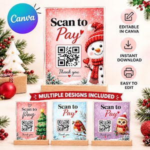 Puede incluir: Un letrero rectangular de acrílico con base de madera que presenta un código QR, el texto Scan to Pay y una ilustración de un muñeco de nieve. El diseño incluye patrones de copos de nieve rojos y blancos. Otros letreros muestran un árbol.