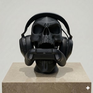 May include: A matte black 3D printed skull sculpture serving as a stand for gaming accessories. The skull wears a pair of black over-ear headphones and holds a black wireless game controller in its open jaw, featuring the Xbox logo on the device.