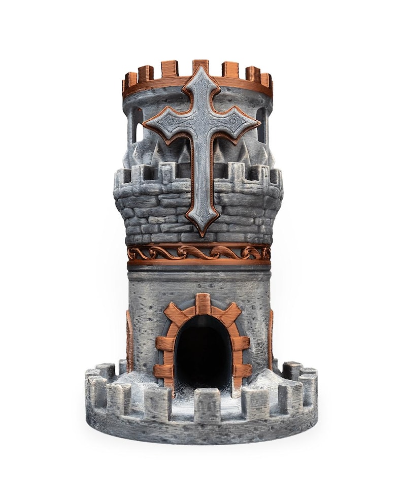May include: A gray and copper-colored dice tower featuring a stone-textured cylindrical structure with a crenelated top, a central arched doorway, and a prominent silver-toned cross emblem mounted on the upper section of the exterior wall.