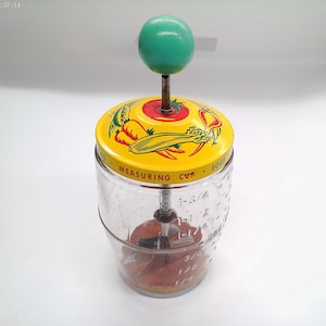 Vintage glass measuring cup food and vegetable chopper, likely made in the 1940s or 1950s