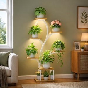 May include: A white metal plant stand with a tree-like structure featuring multiple wooden shelves at varying heights. The stand includes integrated LED lights under several shelves, holding various potted green plants and pink flowers.