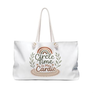May include: A white tote bag with rope handles featuring a graphic of a rainbow, leafy branches, and a fringed mat. The text reads Circle Time Is My Cardio in brown and green lettering, accented by two small hearts on either side of the word Is.