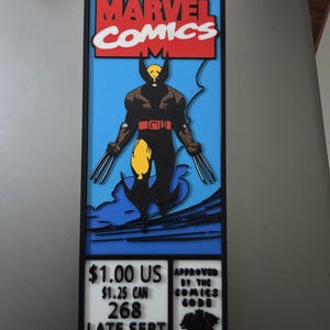 May include: A rectangular wall art piece featuring a layered Marvel Comics graphic of Wolverine in a black and yellow suit with metal claws. The design includes the Marvel Comics logo, issue details, and the Comics Code Authority seal in black frames.
