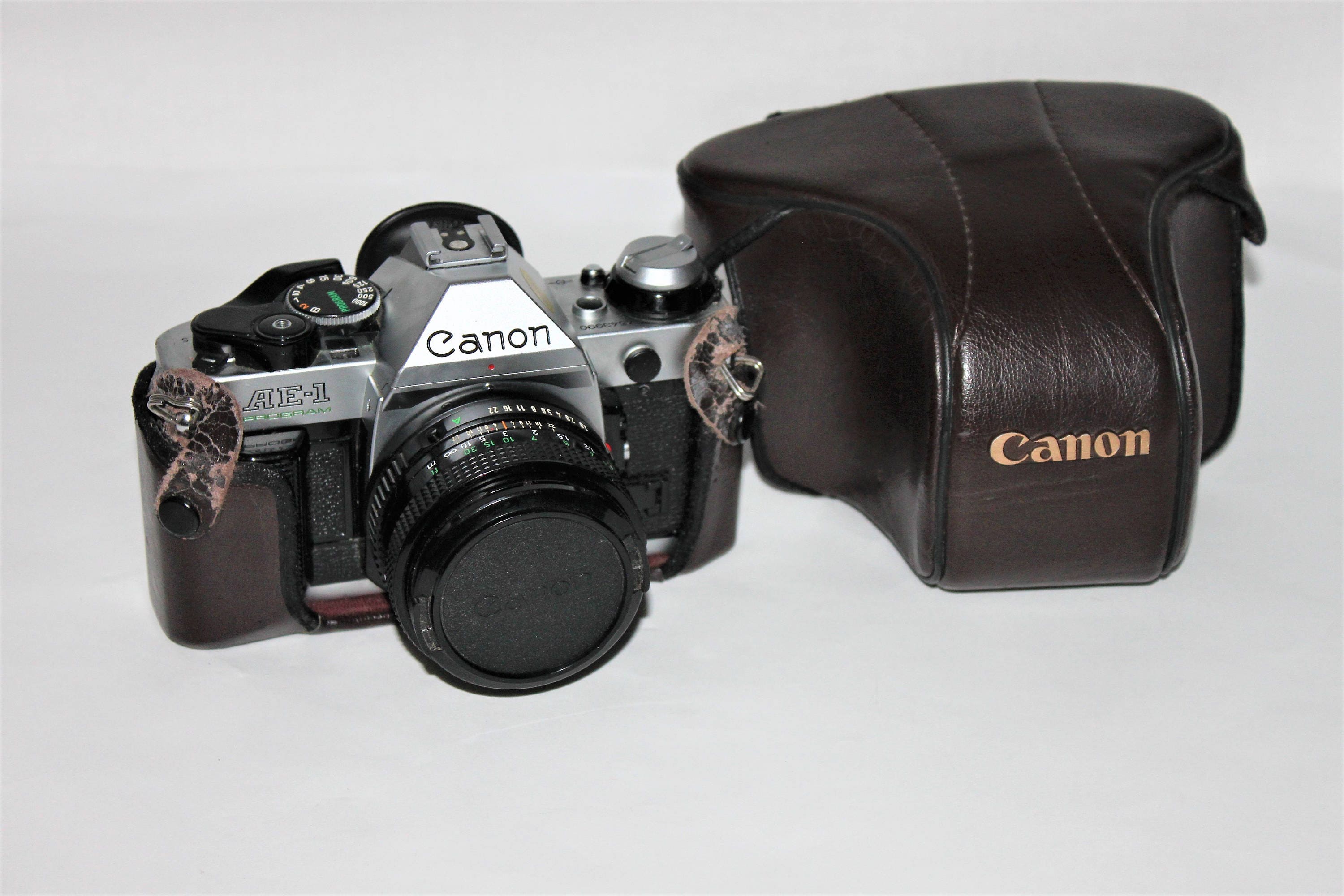 Vintage 1980s Canon AE-1 35mm Film Camera with Leather Case Vintage 1980s Canon AE-1 35mm Film Camera with Leather Case