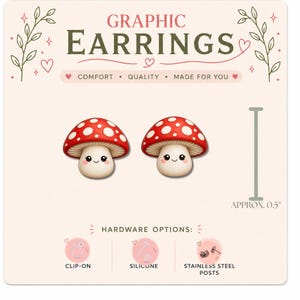 May include: A pair of mushroom-shaped earrings with red caps and white spots on a display card labeled GRAPHIC EARRINGS. The mushrooms have smiling faces. The card shows hardware options including clip-on, silicone, and stainless steel posts, with a 0.5 inch scale reference.