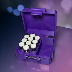 May include: A purple plastic storage case with a hinged lid, featuring a molded interior insert designed to hold nine small glass vials with white caps. The case includes a separate open compartment on the right side and a metal latch closure.
