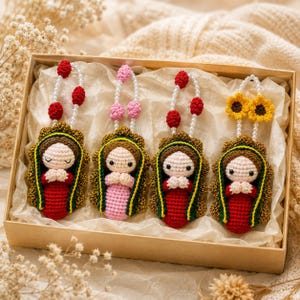 May include: A set of four crocheted figures in a box, each featuring a doll with a dark green and gold mantle, light skin, and hands clasped in prayer. Three dolls have red or pink bodies and red bead accents, while one has yellow sunflowers.