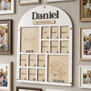 May include: A white arched wooden school years photo board with the name Daniel and the text My School Years. It features slots for photos labeled PreK through Senior, including a 5"x7" space and 2"x3" slots, with a graduation cap and diploma icon.