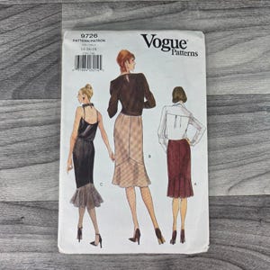 May include: A Vogue Patterns sewing pattern envelope, number 9726, featuring illustrations of three different skirt styles labeled A, B, and C. The white envelope displays the brand logo, size range 14-16-18, and a barcode on the upper left corner.