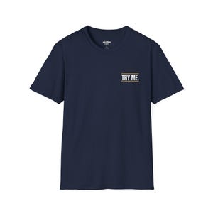 A black t-shirt with the text "TRY ME" printed on the front.