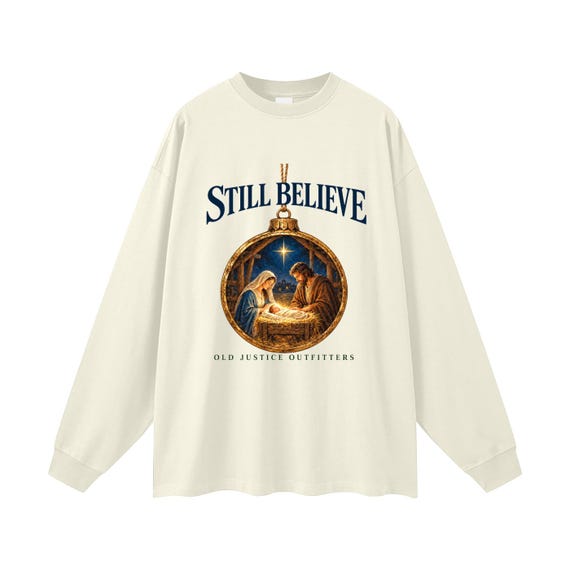 Milk Tea long-sleeve shirt printed with traditional Nativity ornament artwork and the words Still Believe.
