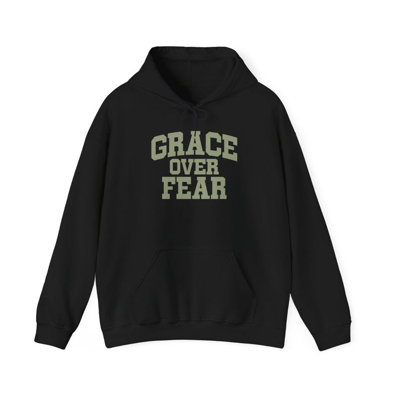 Black Old Justice Outfitters pullover hoodie with muted sage GRACE OVER FEAR lettering on the front.