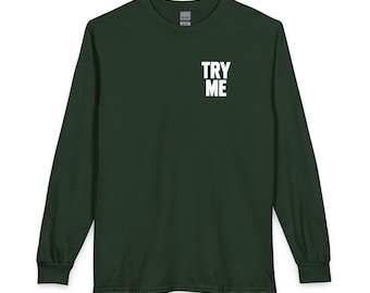 May include: A dark forest green long-sleeve t-shirt featuring a crew neckline and ribbed cuffs. On the upper left chest area, the text TRY ME is printed in bold, white, sans-serif capital letters, positioned vertically in two stacked lines.