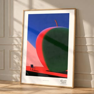 May include: A framed art print featuring a large, stylized apple with a red side and a dark green side against a blue sky. A small black chair sits on a red surface in the foreground. The text "Apple Green Sound" and a logo are at the bottom.