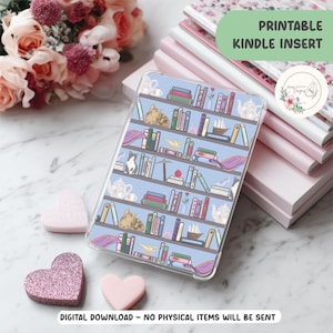 May include: A clear Kindle case with a blue bookshelf design featuring books, cats, teapots, and a magic lamp. The case is surrounded by pink hearts and a stack of notebooks. The text "PRINTABLE KINDLE INSERT" is visible.