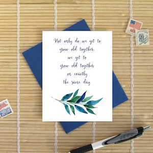 May include: A white card with a blue watercolor leaf design and the text "Not only do we get to grow old together, we get to grow old together on exactly the same day."