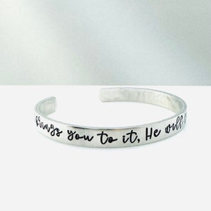 May include: Silver bracelet with the inscription "If God brings you to it, He will see you through it."