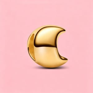 May include: A polished gold-tone metal charm shaped like a crescent moon. The charm features a smooth, reflective surface with a curved silhouette and a hollow opening on the side, designed for attachment to a bracelet or necklace chain.
