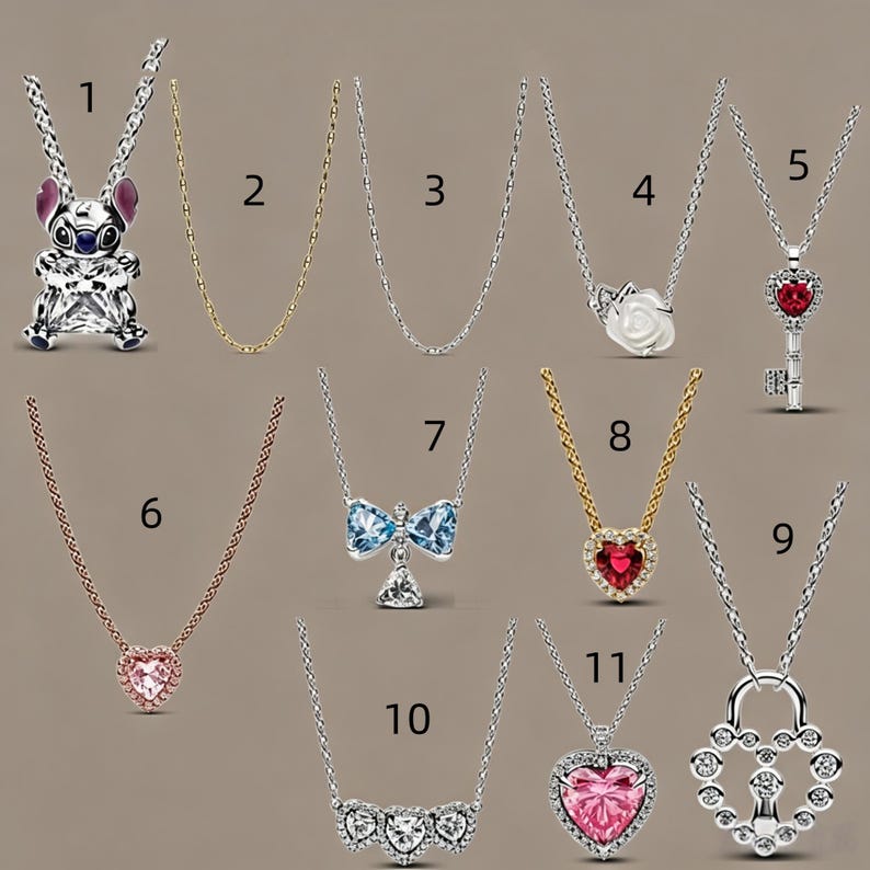 May include: A collection of eleven silver and gold-toned necklaces featuring various pendants, including a Stitch character, a white rose, a key with a red stone, a blue bow, heart-shaped stones in pink and red, and a heart-shaped padlock design.