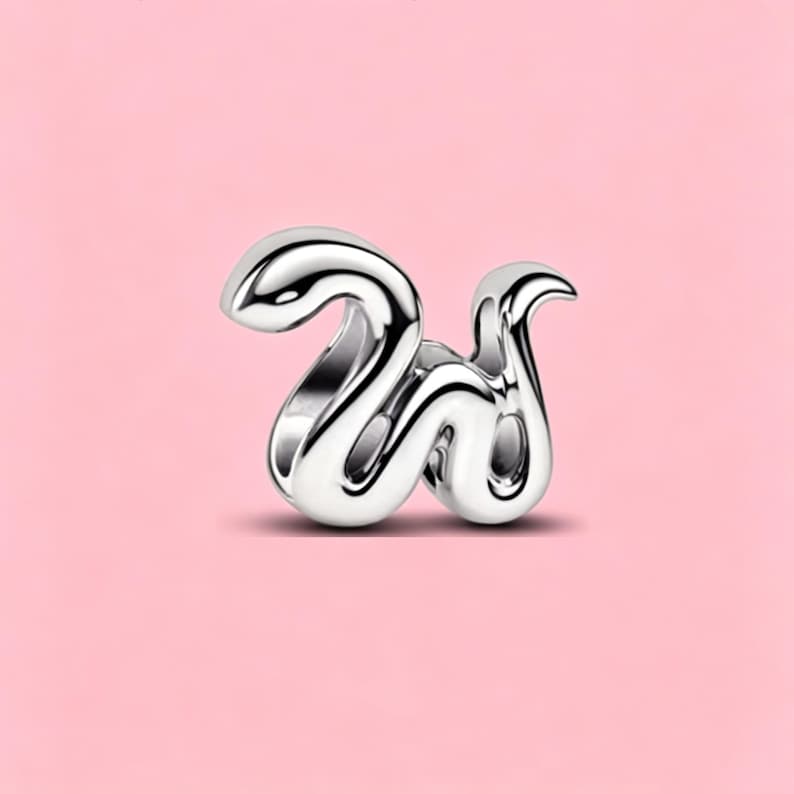 May include: A polished silver-tone metal charm shaped like the lowercase letter w. The design features a smooth, fluid, and rounded aesthetic with a reflective surface that catches light, creating high-contrast highlights and deep shadows.