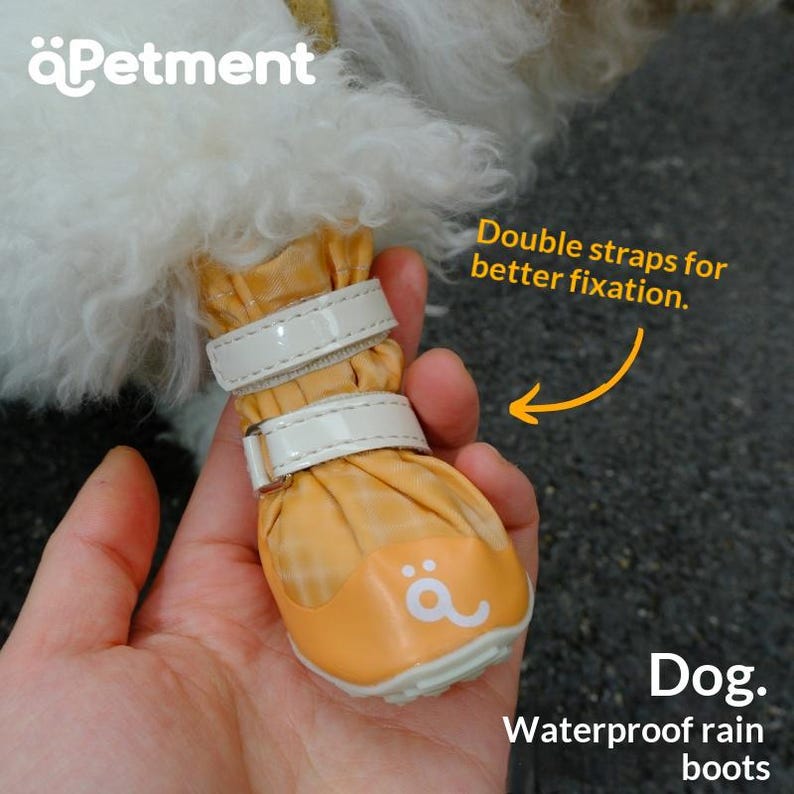 May include: A yellow plaid waterproof dog boot featuring two white adjustable straps for fixation, a white rubber toe cap with a small white logo, and the text Petment, Double straps for better fixation, and Dog. Waterproof rain boots.