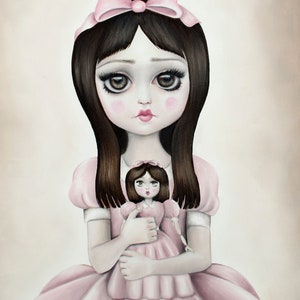 May include: A young girl with long dark hair and a pink bow in her hair is holding a smaller doll with a pink dress. Both dolls have large eyes and are wearing pink dresses.