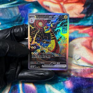 May include: A holographic Ampharos ex trading card featuring a yellow and black creature with a glowing red orb, electric blue energy swirls, and the text Electro Ball and Thunderstrike Tail, with 330 HP and a lightning energy symbol.