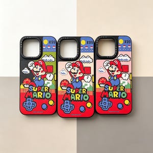 May include: Three rectangular phone cases featuring a Super Mario graphic with a red, blue, and yellow color scheme. Each case displays the text Super Mario, a pixelated character, a coin icon with X99, and a game controller button layout.