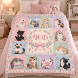 May include: A rectangular fleece blanket featuring a grid of illustrations of various kittens in pastel colours. The centre panel displays the name Amelia in pink script, surrounded by a floral wreath and a large pink bow. The kittens are depicted sleeping, playing with yarn, or sitting among flowers and butterflies.