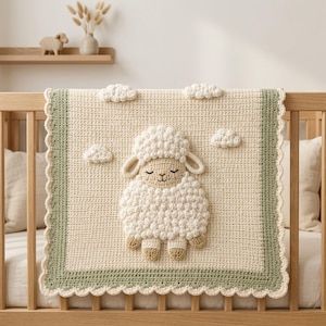 May include: A cream-colored crochet baby blanket featuring a central textured sheep motif with closed eyes. The blanket has a sage green border with a scalloped edge and includes small, raised crochet clouds scattered across the cream background.