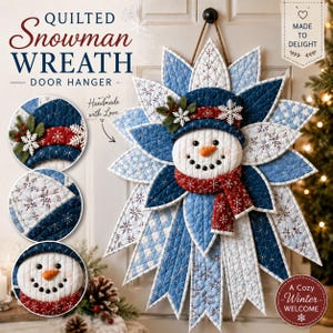 May include: A quilted snowman wreath door hanger featuring a central snowman face with a carrot nose, wearing a dark blue hat and a red scarf. The wreath is constructed from layered, star-shaped fabric petals in shades of blue and white.