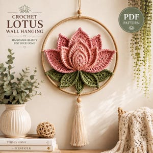 May include: A crochet lotus wall hanging featuring a pink lotus flower with green leaves centered inside a circular tan hoop. A long cream-colored tassel hangs from the bottom. Text on the image reads: CROCHET LOTUS WALL HANGING, HANDMADE BEAUTY FOR YOUR HOME, and PDF PATTERN.