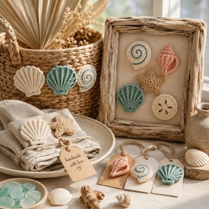 May include: A collection of crocheted seashell and starfish decorations in shades of cream, teal, and pink. The set includes a woven basket, a framed display, linen napkins with a tag reading handmade with love, and three gift tags with attached shells.