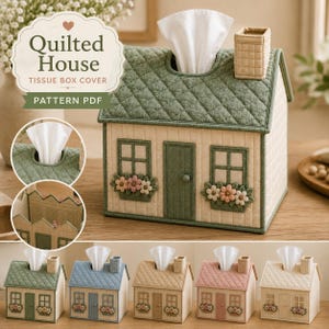 May include: A house-shaped tissue box cover featuring a quilted green roof, cream-colored walls, a chimney, and windows with flower boxes. The design includes a central door and a top opening for tissues. The text Quilted House TISSUE BOX COVER is visible.